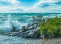 Waves crashing on Mackinac Island rocks with Mackinac Bridge in background Royalty Free Stock Photo