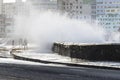 Waves crashing on the Malecon of Havana, Cuba, the people getting wet