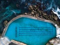 Waves crashing ocean pool by drone