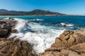 Waves crashing onto rocks near Algajola beach in Corsica Royalty Free Stock Photo