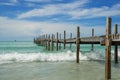 Waves crashing onto the shore and wood bridge on sea