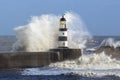 Waves crashing over Lighthouse - England Royalty Free Stock Photo