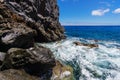 Waves crashing over rock formation Royalty Free Stock Photo