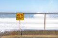 Waves crashing over sea wall at high tide Royalty Free Stock Photo