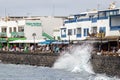 Waves crashing over the sea wall onto the promenade in Playa Blanca, Lanzarote, Spain Royalty Free Stock Photo
