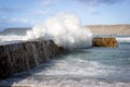 Waves crashing over the sea wall Royalty Free Stock Photo