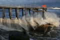 Waves crashing into pier