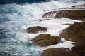 Waves crashing on rocks, Atlantic Ocean. Azure sea waves with white foam breaking on coast. Splash of aquamarine sea water. Royalty Free Stock Photo