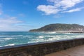 Waves crashing on rocks of San Sebastian coast, Spain. Scenic bay of Biscay in San Sebastian, Donostia. Surf concept. Royalty Free Stock Photo