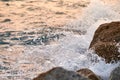 Waves crashing on the rocks at sunset. Royalty Free Stock Photo