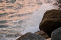 Waves crashing on the rocks at sunset. Royalty Free Stock Photo