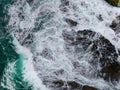 Waves crashing on seashore rocks,Top view sea surface waves background Royalty Free Stock Photo