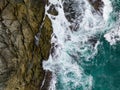 Waves crashing on seashore rocks,Top view sea surface waves background Royalty Free Stock Photo