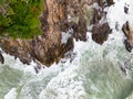 Waves crashing on seashore rocks,Top view sea surface waves background Royalty Free Stock Photo