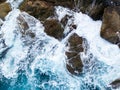 Waves crashing on seashore rocks,Top view sea surface waves background Royalty Free Stock Photo