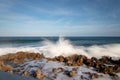 Waves crashing to some rocks at the coast shore - longexposure photography
