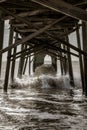 Waves crashing under the pier at Holden Beach Royalty Free Stock Photo