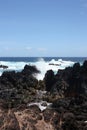 Waves crashing into volcanic rock on the shore of Laupahoehoe Point on the Hamakua Coast, Hawaii Royalty Free Stock Photo