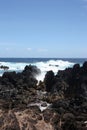 Waves crashing into volcanic rock on the shore of Laupahoehoe Point on the Hamakua Coast, Hawaii Royalty Free Stock Photo