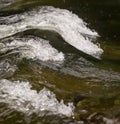 Waves cresting in the flow of a river