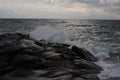 Waves crushing on the rocks at the beach on the sea coast at Jomfruland Island in Norway, Skagerrak