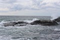 Waves crushing on the rocks at the beach on the sea coast at Jomfruland Island in Norway, Skagerrak