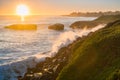 Waves crushing on the rocky shoreline at sunset, Santa Cruz, California