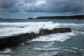 Waves engulf the the harbour wall at Sennen Cove Cornwall UK Royalty Free Stock Photo