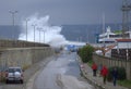 Waves flooding breakwater thrill seekers