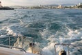 Waves behind the stern of the yacht when leaving the port Royalty Free Stock Photo