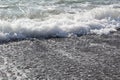 Waves with foam break on the beach shore on the Black Sea Royalty Free Stock Photo