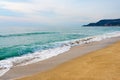 Waves with foam hitting sand on Kleopatra beach in Alanya, Turkey.