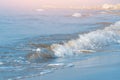 Waves with foam on the sea green color, long sandy beach Royalty Free Stock Photo