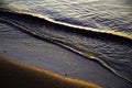 Waves on a golden sand, beach, sunrise in Isthmia, Greece