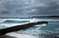 Waves hit the the harbour wall at Sennen Cove Cornwall UK Royalty Free Stock Photo