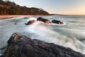 waves hitting rocks in the morning light at beach on nsw south coast of australia Royalty Free Stock Photo