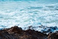 Waves hitting rocks sunrise beach sea Royalty Free Stock Photo