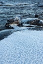 Ice frozen over rocks in lake shore