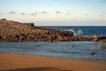 Waves impacting on an red rock formation