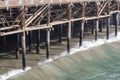 Waves just beginning to break against wood pilings of an ocean pier, Santa Monica CA