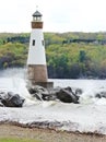 High waves break and splash over Cayuga Lake lighthouse Royalty Free Stock Photo