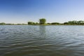 Waves on the lake, shore and blue sky Royalty Free Stock Photo