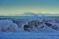 waves of the Mediterranean Sea rolling up and mountains on the horizon