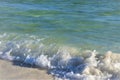 Waves from the ocean seethe and foam on the shore Royalty Free Stock Photo