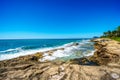 Waves of the Pacific Ocean crashing onto the rocky shoreline of the west coast of the island of Oahu Royalty Free Stock Photo