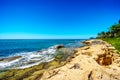 Waves of the Pacific Ocean crashing on the rocks on the shoreline of Ko Olina on the island of Oahu