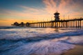 Waves in the Pacific Ocean and the pier at sunset Royalty Free Stock Photo