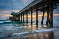 Waves in the Pacific Ocean and the pier at sunset Royalty Free Stock Photo