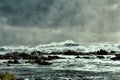 waves of Pacific ocean and rugged beauty of basalt rocks