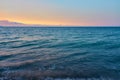 Waves on a pebble beach on a sunset. Natural background. Royalty Free Stock Photo